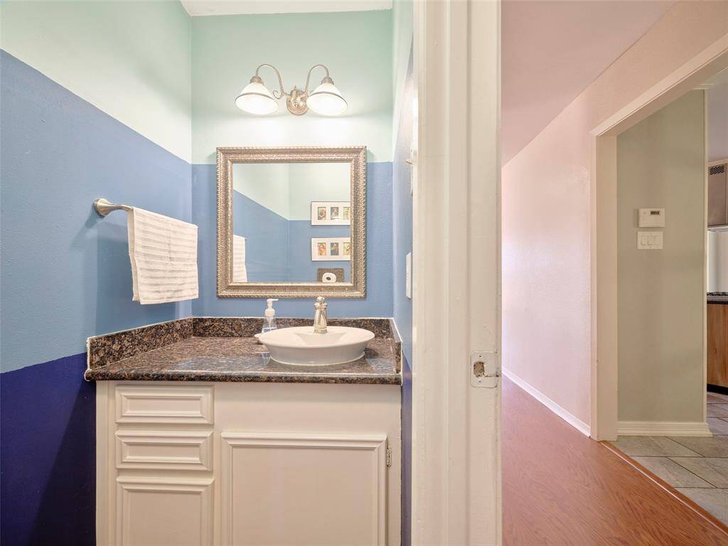 Conveniently located powder room adjacent to the kitchen.