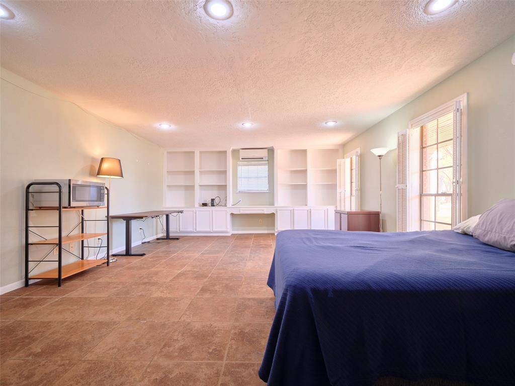Discover the potential of this multi-functional lower-level room, offering seamless adaptability as a guest suite, private office, entertainment hub, or fitness area.