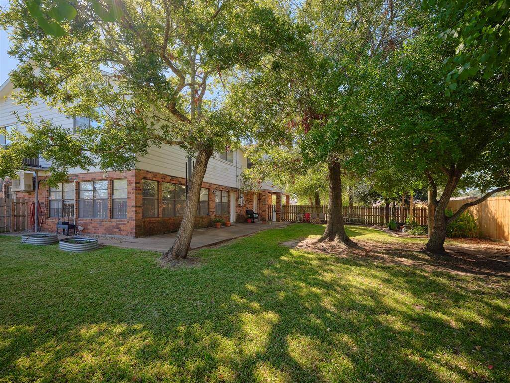Large backyard ideal for gatherings or peaceful retreats, framed by the elegance of a two-story home.