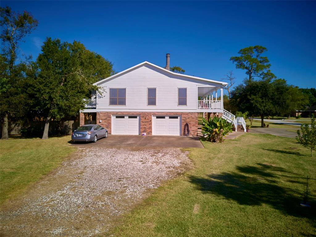 Ample parking with a large driveway and oversized garage.