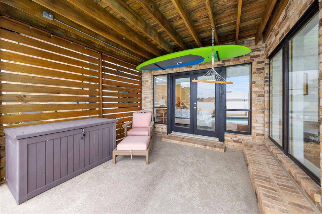 Step out onto the private back patio from the primary bedroom— the perfect spot to start your day with a cup of coffee while taking in the breathtaking views of Lake Conroe.