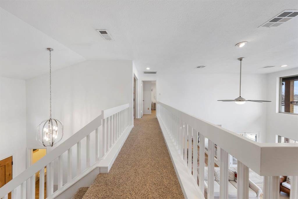 Upstairs, a stunning catwalk connects the bedrooms on either side while offering a breathtaking view overlooking the family room below.
