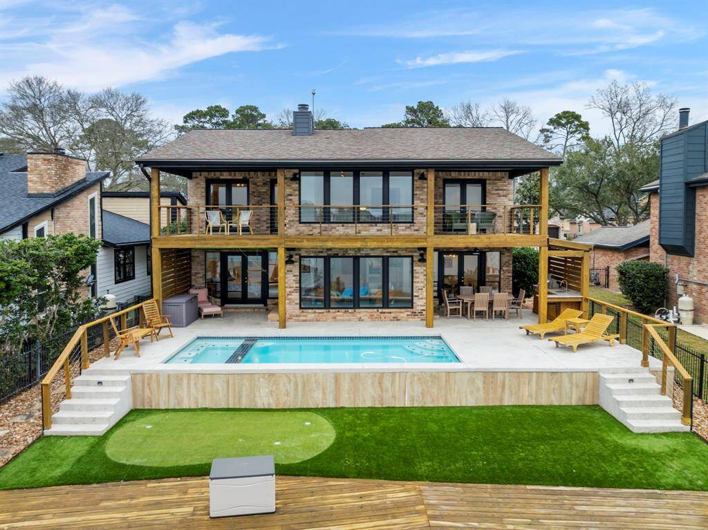 Gorgeous updated exterior featuring fresh paint, modern railings, integrated speakers and lighting, plus a complete backyard transformation for the ultimate lakeside retreat!