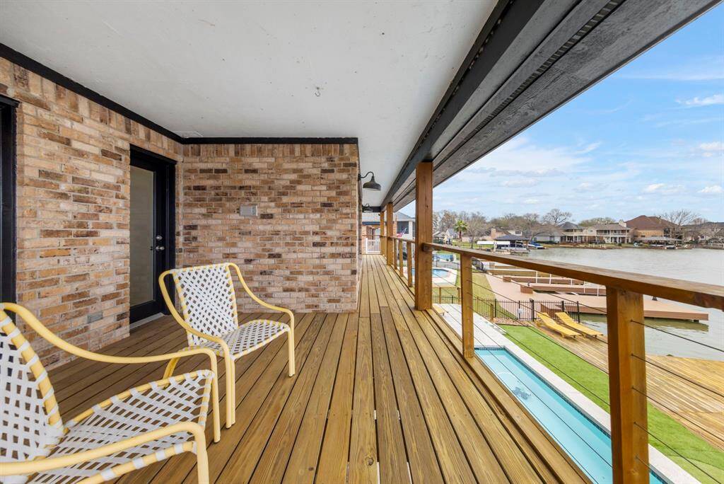 A spacious wrap-around second-floor deck offers stunning panoramic views of Lake Conroe.