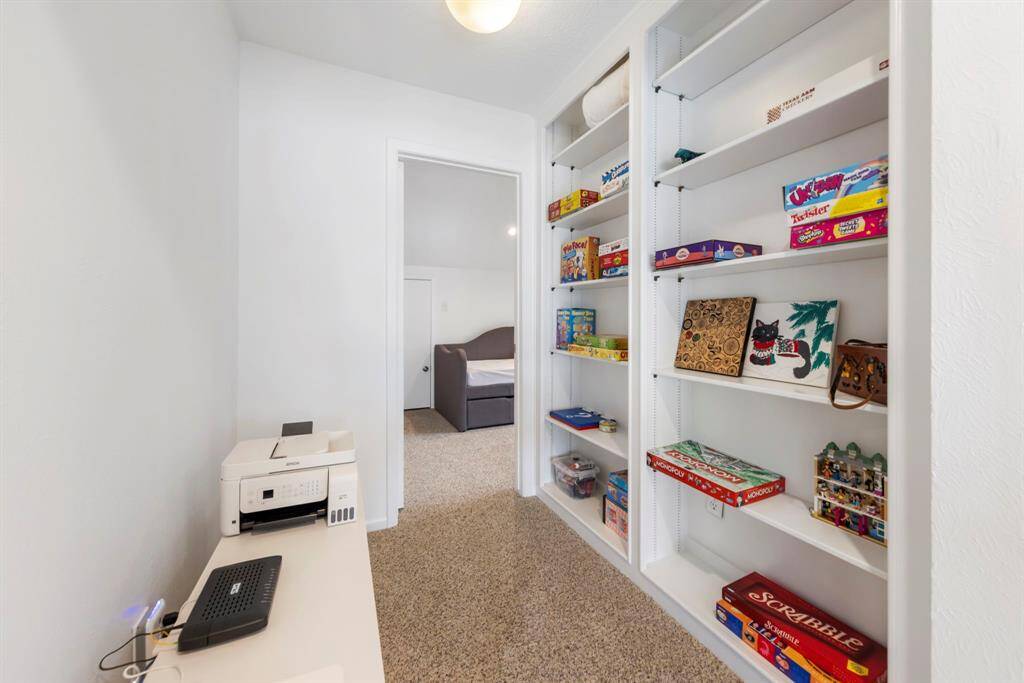 Upstairs to the left, you'll find two additional spacious bedrooms with a convenient storage nook or built-in bookshelf nestled between them.
