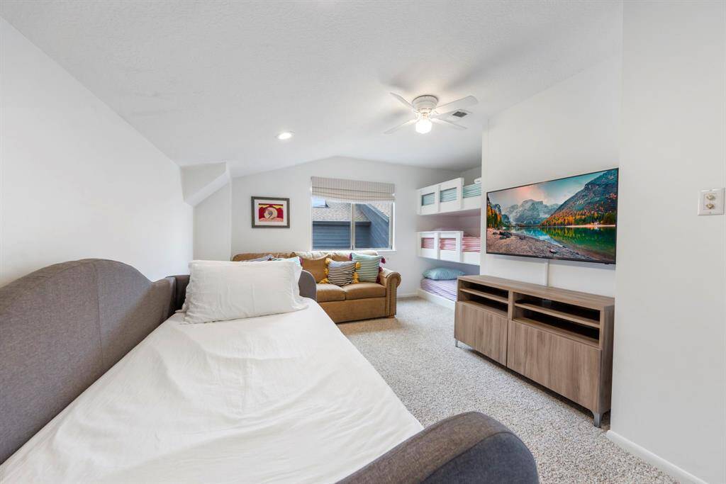 Two of the three spacious upstairs bedrooms featuring plush carpet and ample space, perfect for accommodating multiple guests.