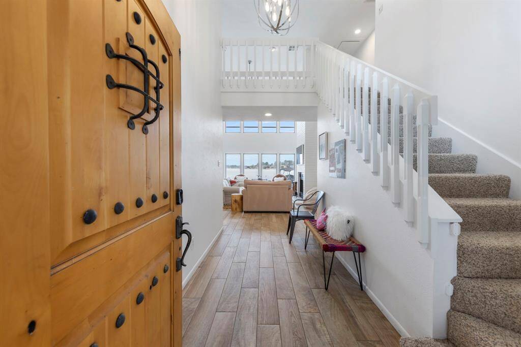 Step inside and be greeted by breathtaking lake views! Soaring ceilings, expansive windows, and fresh white paint create a bright, airy, and inviting atmosphere.