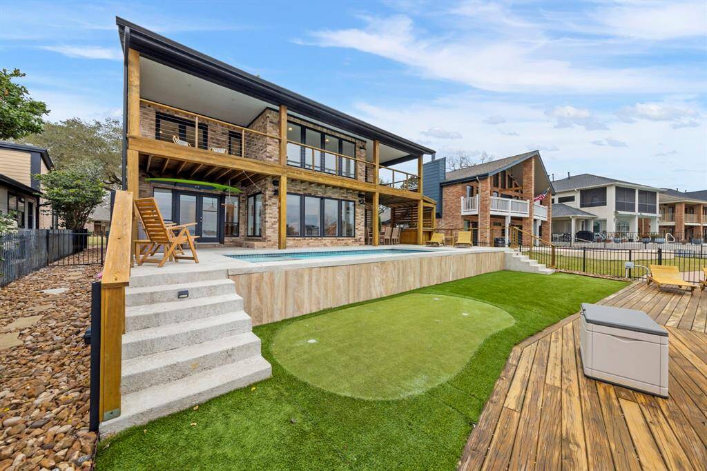Enjoy a low-maintenance backyard featuring rock and turf, complete with a putting green for endless outdoor fun!