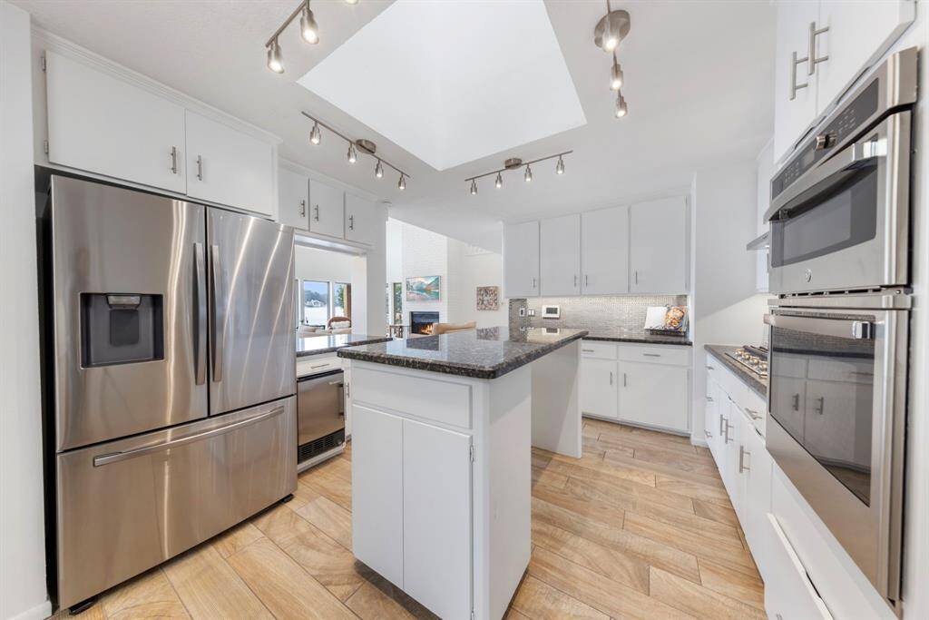 High-end stainless steel appliances, including a dedicated ice machine, elevate the kitchen’s functionality. Plus, the refrigerator, washer, and dryer all convey with the home for added convenience!