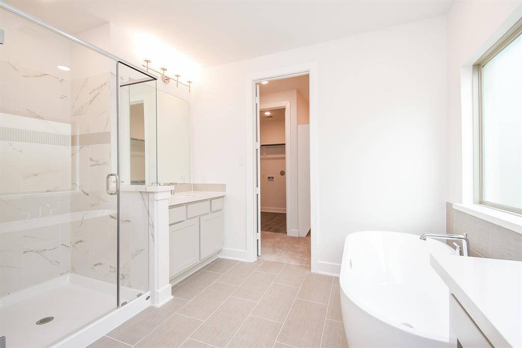 legant walk-in shower with sleek glass enclosure and ample natural light.
