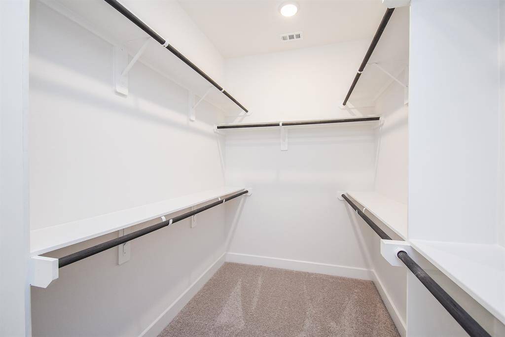pacious walk-in closet with abundant shelving and storage solutions.