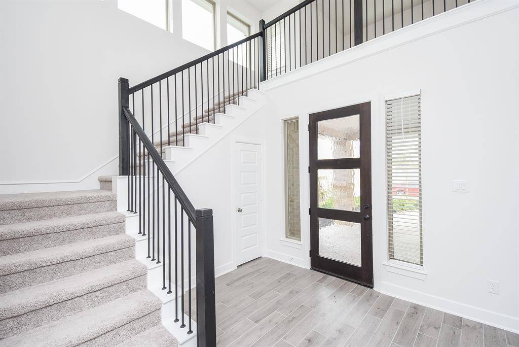 Bright and airy foyer with clean architectural lines.
