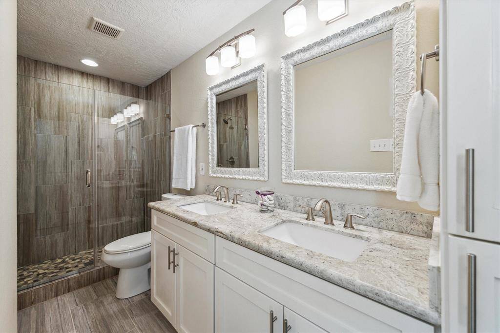 The spa-like ensuite bath provides a luxurious and rejuvenating experience. Elegant granite countertops, and sleek tile work enhances the aesthetics.