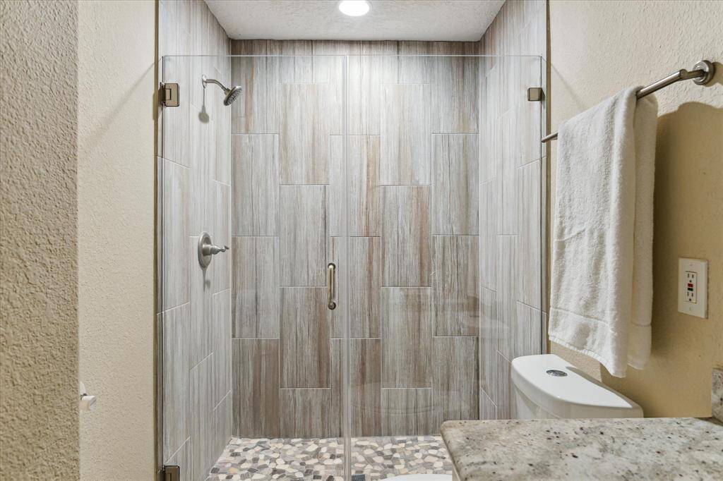 A busy morning shower or a long, indulgent escape, this bath delivers the perfect experience. A spacious walk-in shower, with frameless glass doors, provides a "take me away" rejuvenation.