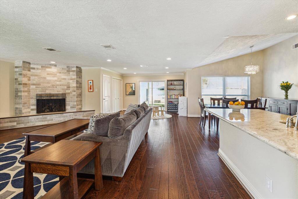 The home has been redesigned with a modern, open floor plan. A stunning fireplace serves as a striking focal point, adding warmth and elegance to the living area.