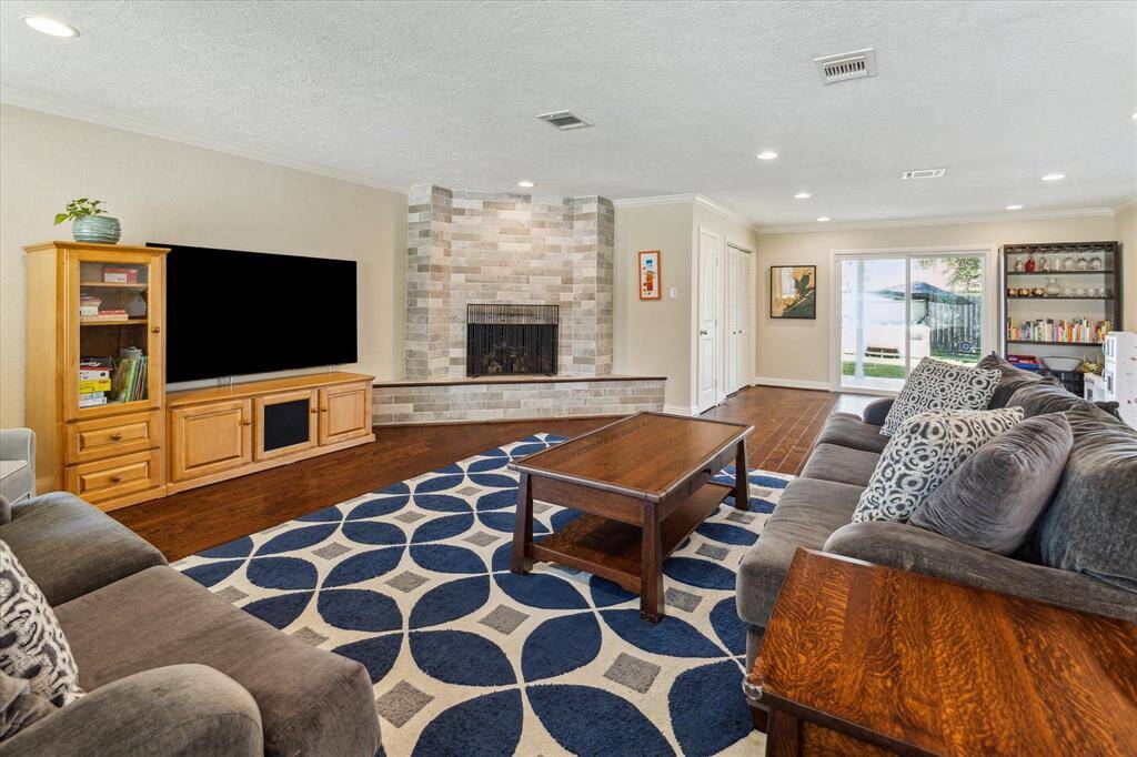 The living area boasts rich engineered wood floors, offering both style and durability while creating a warm and inviting atmosphere perfect for relaxing or entertaining.