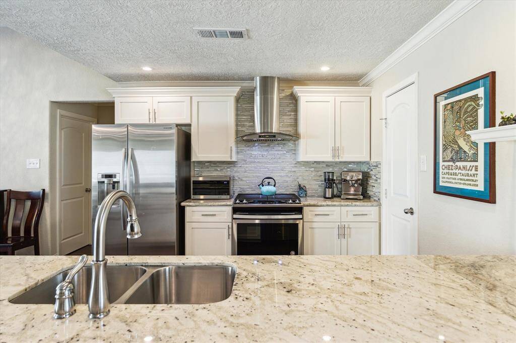 The thoughtfully designed kitchen boasts modern cabinetry and elegant countertops. A spacious walk-in pantry provides ample storage, ensuring an organized and efficient culinary experience.