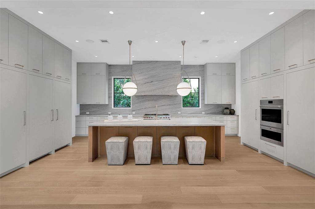 The downstairs large guest bedroom offers flexible space; it could also be used as an exercise room or an additional office. It has its own patio and its full bath also opens to the backyard and acts as the pool bath.