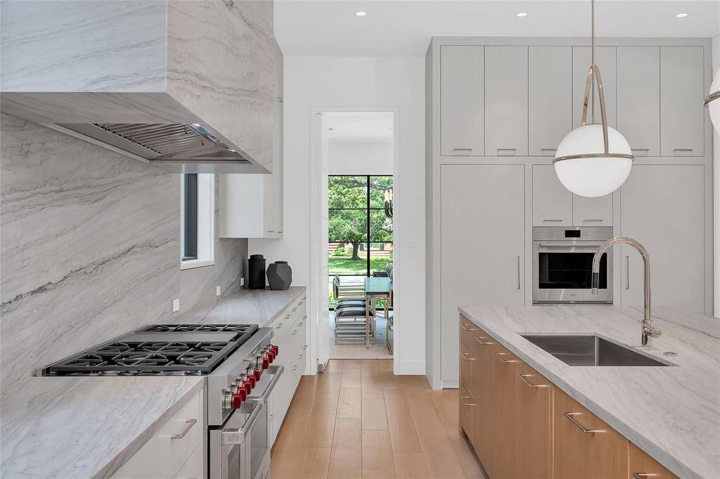 Large home office with filing cabinets, shelving and leathered finished quartzite counters.