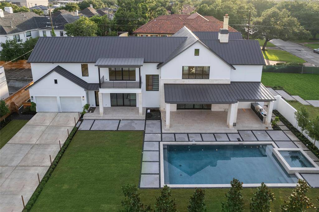 The design of the home displays a contemporary version of a Charleston-style home with the primary elevation alongside of the pool and behind a privacy wall. The lot allows for a huge space both inside and outside the wall.