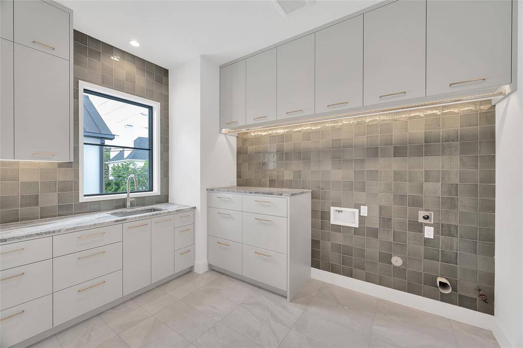 In the transition area from the 3 car garage into the back door, you will find a exceptional mud room space with tons of cabinets, storage nooks, lockers and cubbies.