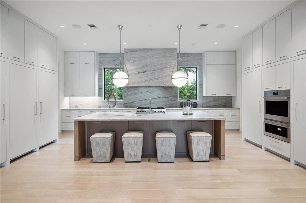 Alternate view from the kitchen with stunning views of the yard and pool.