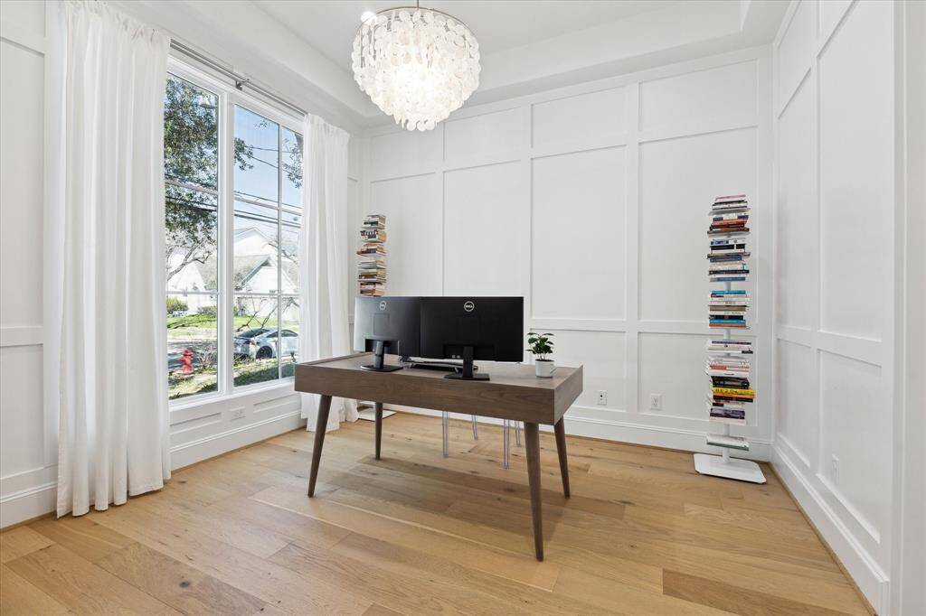 The home office with view of the front yard and attached to a full bath is also an optional downstairs fifth bedroom.