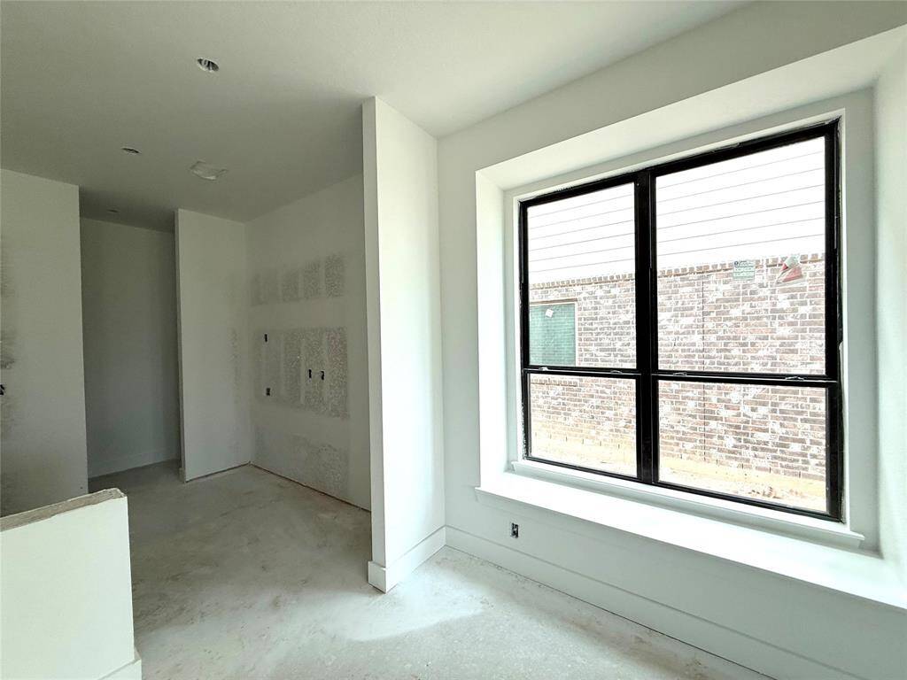 Bathed in natural light from large windows, the space invites you to gather around a styl