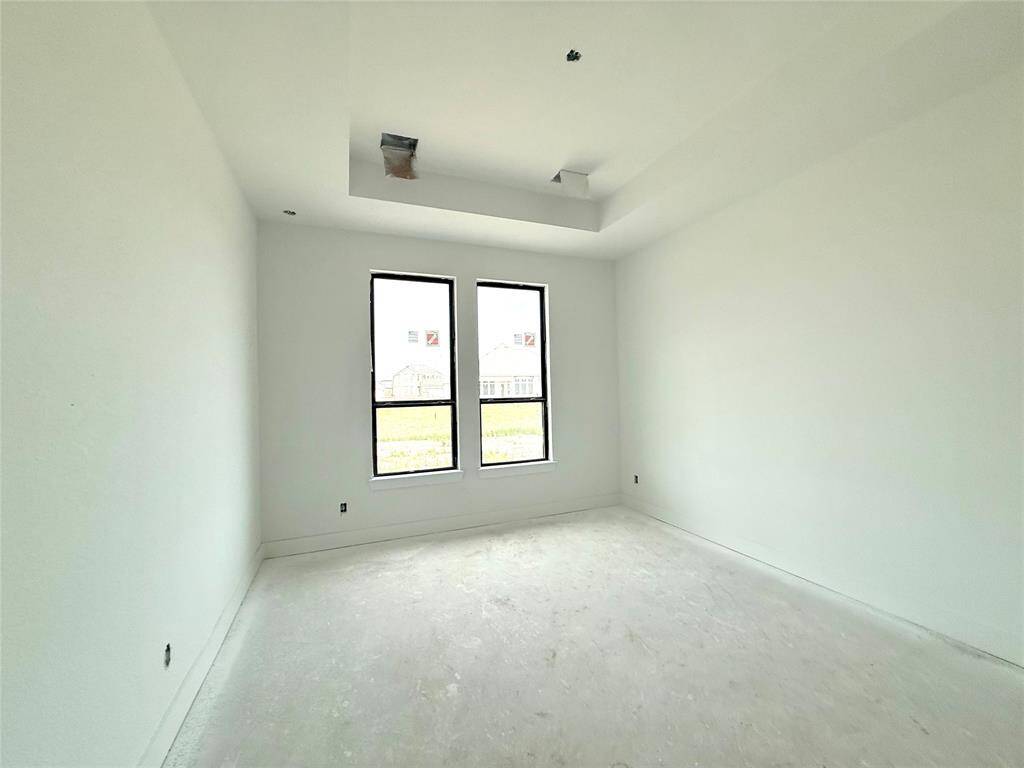 The spacious layout offers plenty of room for a plush king-sized bed, adorned with fluffy