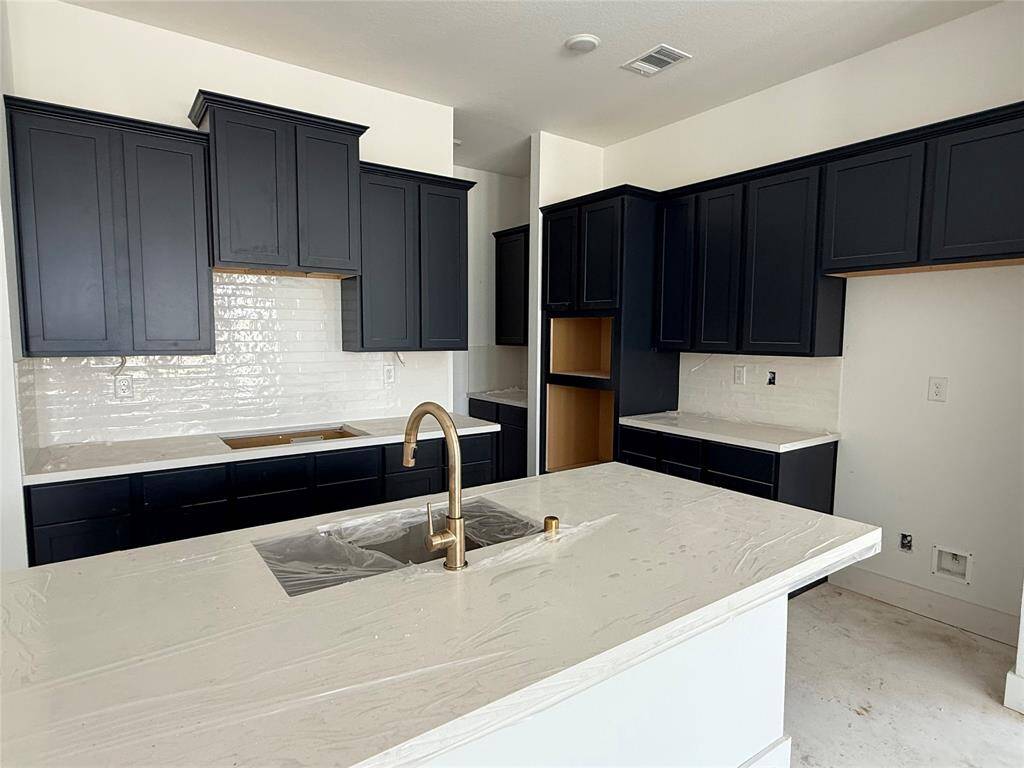 Whip up a batch of Grandma's secret cookie recipe in this sleek stunner of a kitchen wtih