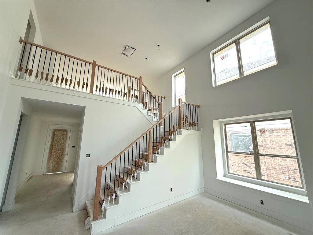 Large windows offer breathtaking views of the surrounding landscape, creating a backdrop t
