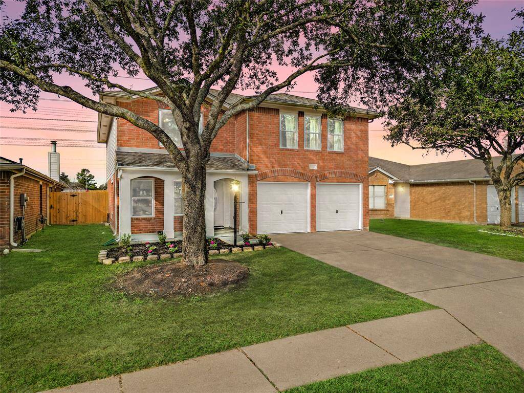 The front of your home exudes warmth and charm, featuring a beautifully designed facade that welcomes you in. A covered front porch adorned with elegant white arches adds a modern touch to the elevation, while a mature tree provides shade and enhances the inviting curb appeal.