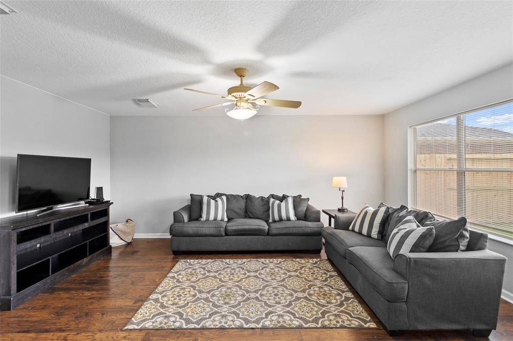 From this angle, your living area reveals its open and airy feel, enhanced by large windows that flood the space with natural light. The bright and welcoming atmosphere makes it an ideal spot to relax, connect, and enjoy the comfort of your home.