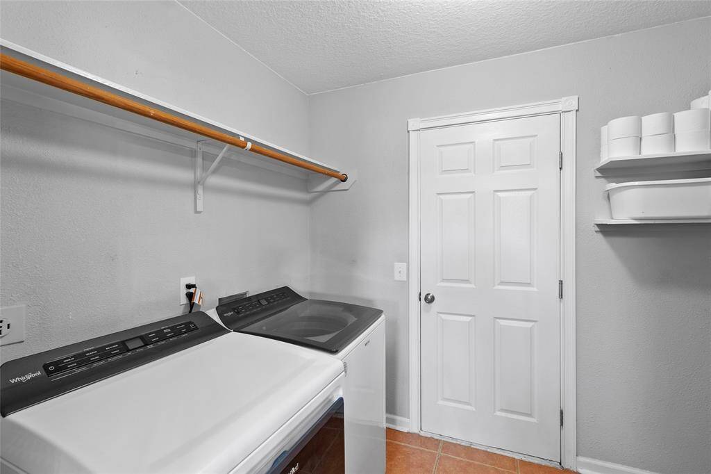Your laundry room is thoughtfully designed for efficiency and convenience, featuring floating shelves that provide stylish and practical storage. With a functional layout and ample space, this area makes washing, drying, and folding effortless while keeping everything neatly organized.