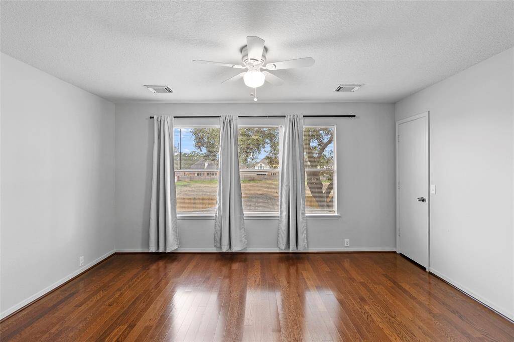 From this angle, your upstairs game room showcases its expansive open space, creating a seamless and airy flow. Large windows flood the room with natural light, enhancing its warm and inviting ambiance, making it the perfect spot for entertainment, relaxation, or game nights.