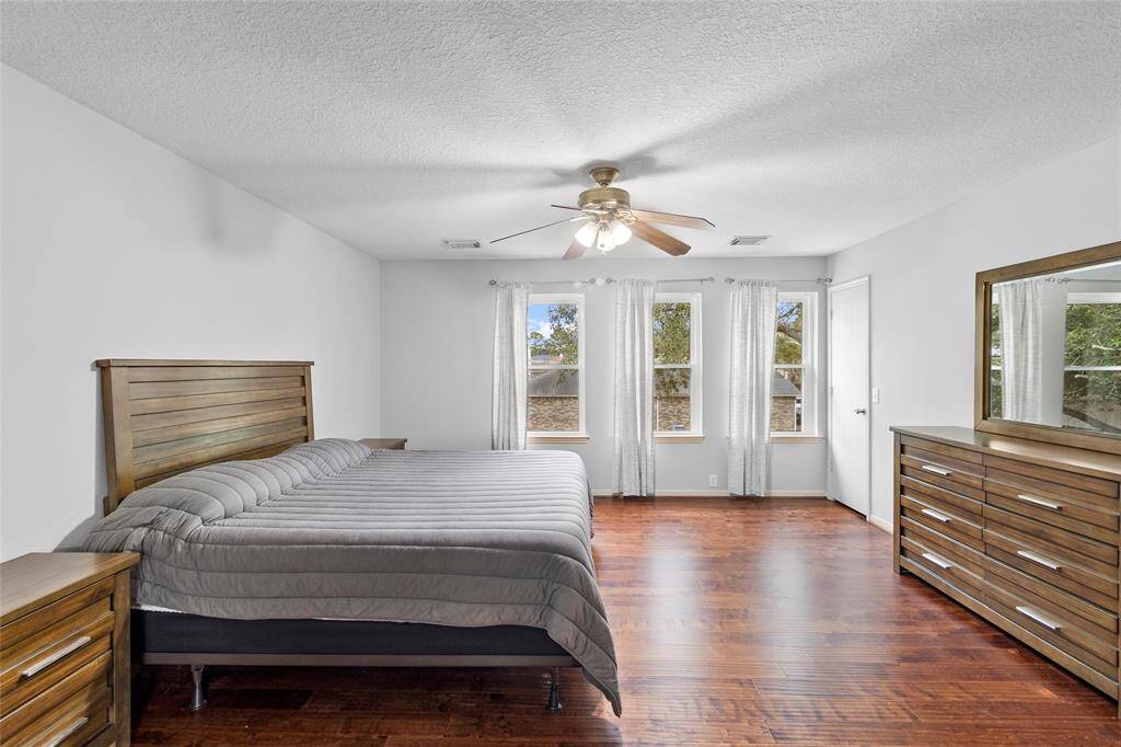 From this angle, your primary bedroom feels even more inviting, with its open layout and effortless flow into your en-suite bath. Soft natural light streams through large windows, enhancing the warm and tranquil ambiance—perfect for rest and relaxation.