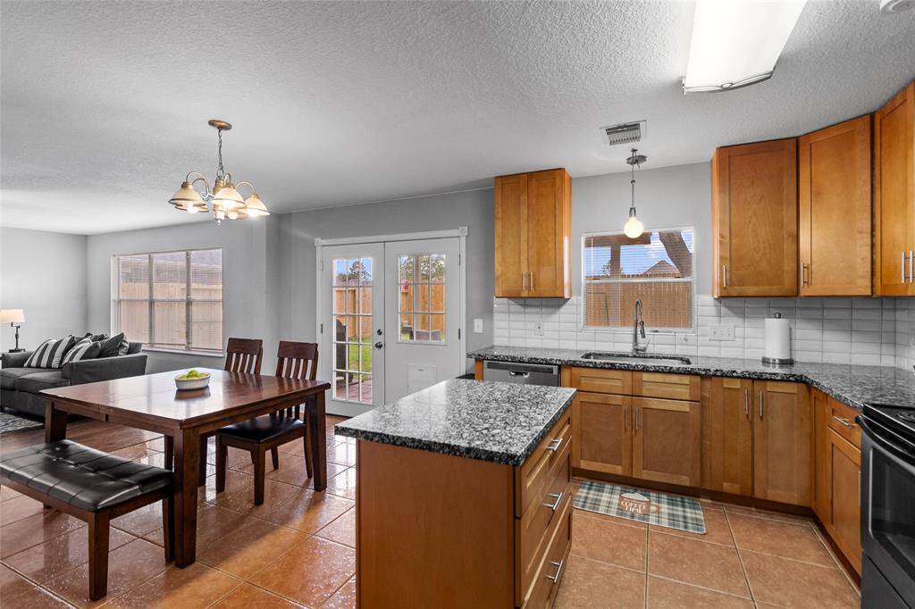 Your open-concept design seamlessly connects the dining and kitchen areas, creating a functional and accessible space for cooking, dining, and socializing. The granite countertops add a touch of elegance and durability, while the well-placed window over the sink brings in natural light, making everyday tasks more enjoyable.