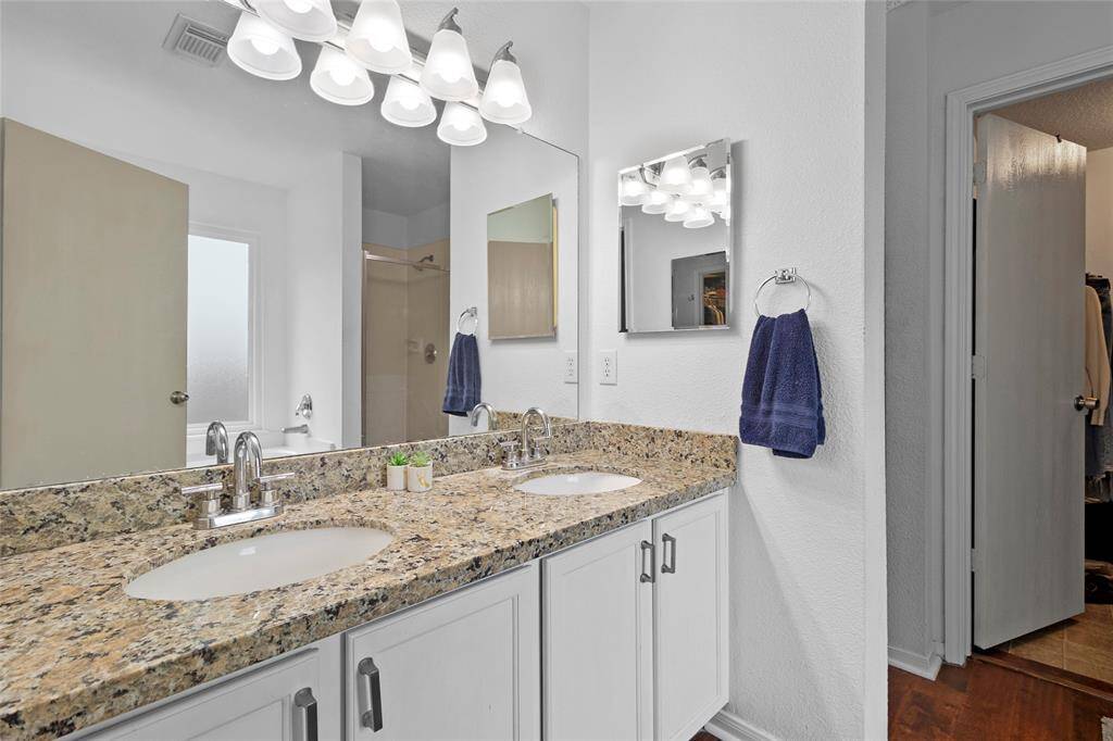 Your primary bath offers the perfect blend of comfort and functionality, featuring a spacious dual-sink vanity for added convenience. Thoughtfully designed with built-in medicine cabinets on both sides, this space provides ample storage while maintaining a clean and organized look. The well-planned layout creates a refreshing atmosphere for your daily routine.