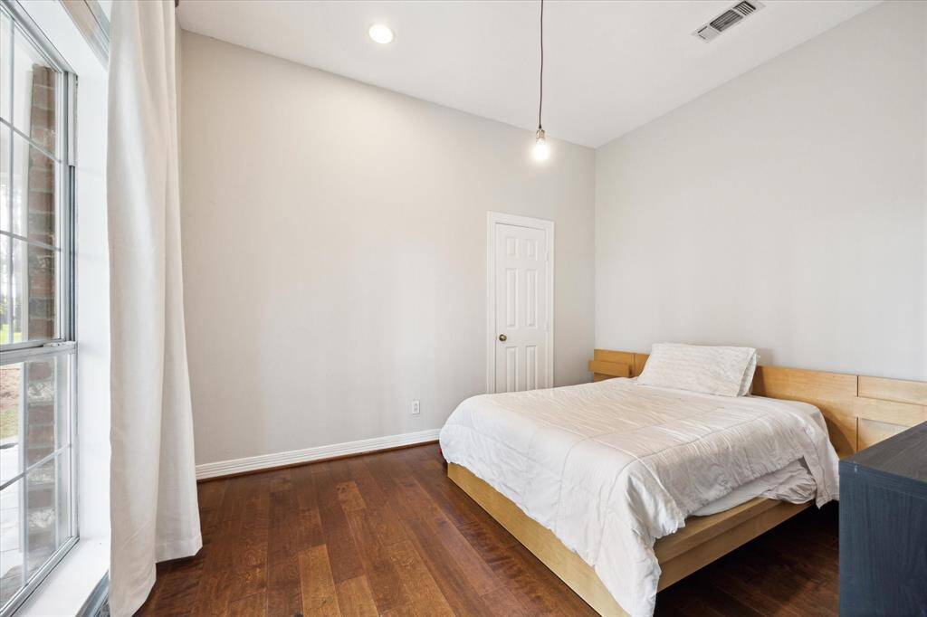 To the left, a cozy yet spacious room offers a versatile space perfect for a bedroom or office