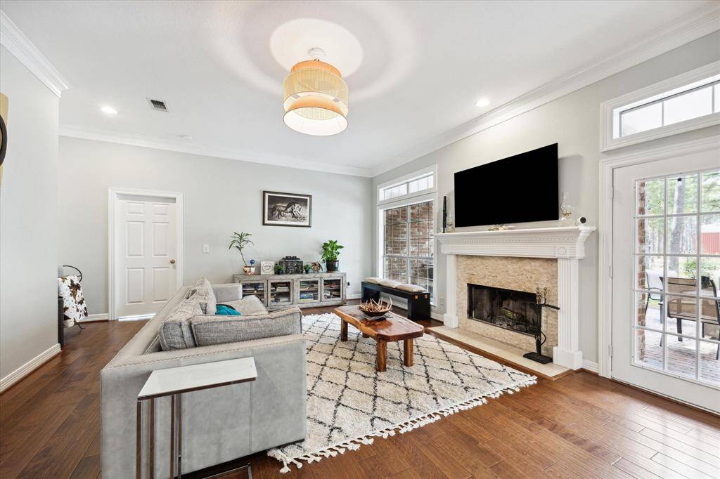 The wooden floors continues seamlessly into the living space as the wood burning fireplace anchors the room