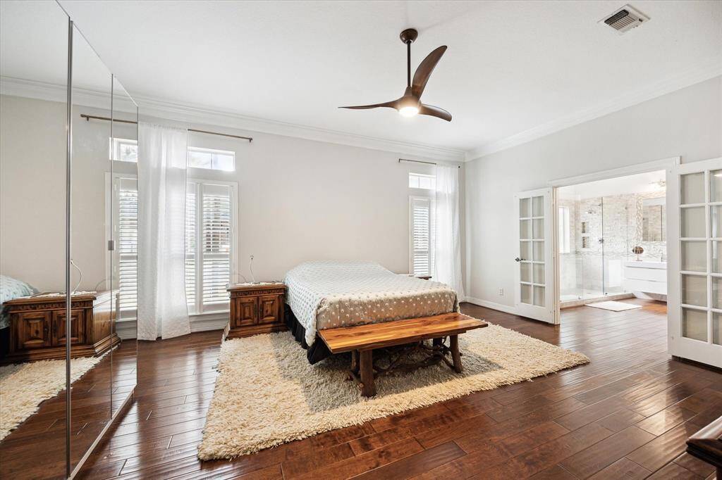 The oversize primary bedroom located on the first floor is a luxurious retreat, offering ample space for relaxation and comfort