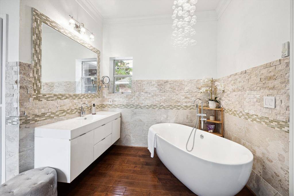 Featuring his and her vanities, an elegant soaking tub and updated features including lighting and hardware