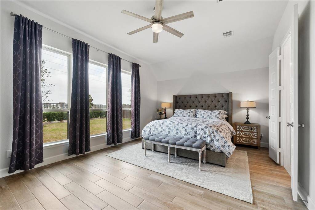 The en-suite bathroom features not one, but TWO walk-in closets, a roomy stand-up shower and a luxurious bathtub, as well as a linen closet and a private water closet.