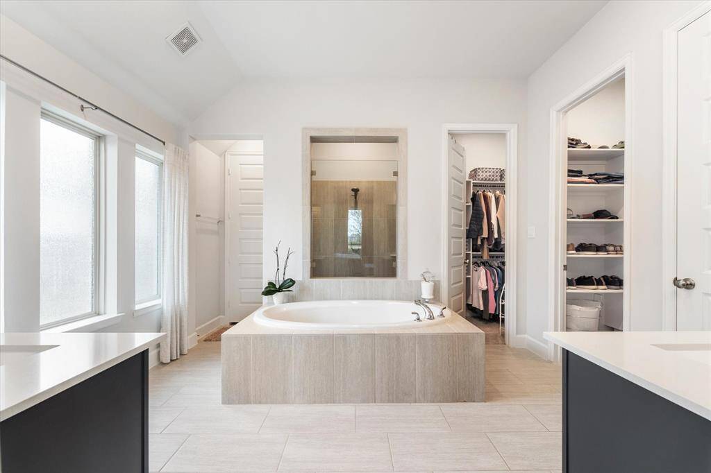 In addition, you'll enjoy two separate sinks, ample vanity space, and elegant frosted glass windows for plenty of natural light while still maintaining privacy.