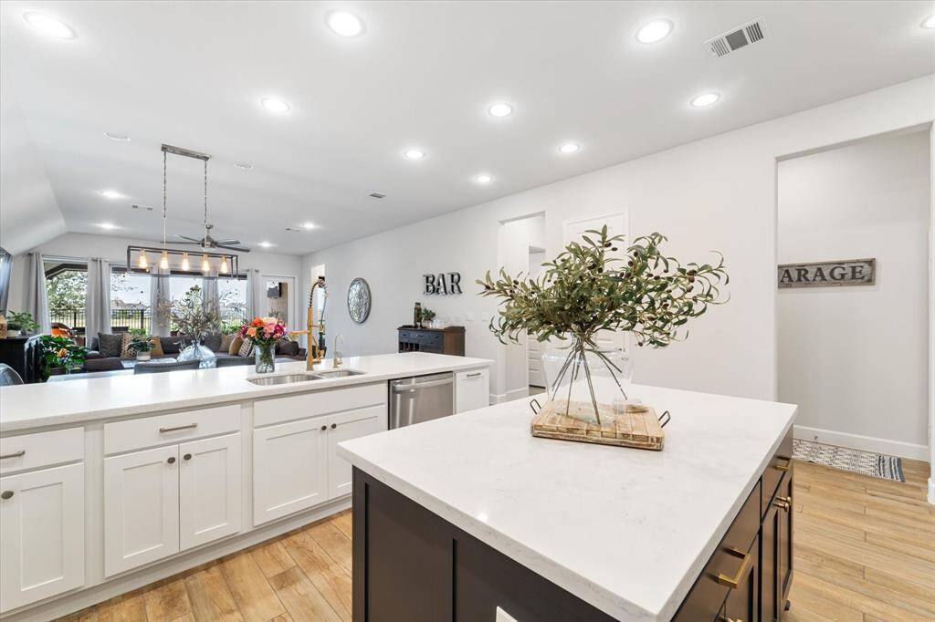 The generous dining area adorned with picture windows, creating the perfect setting for sharing meals with your loved ones. To the left, find TONS of extra storage and additional space for seating a crowd when entertaining!