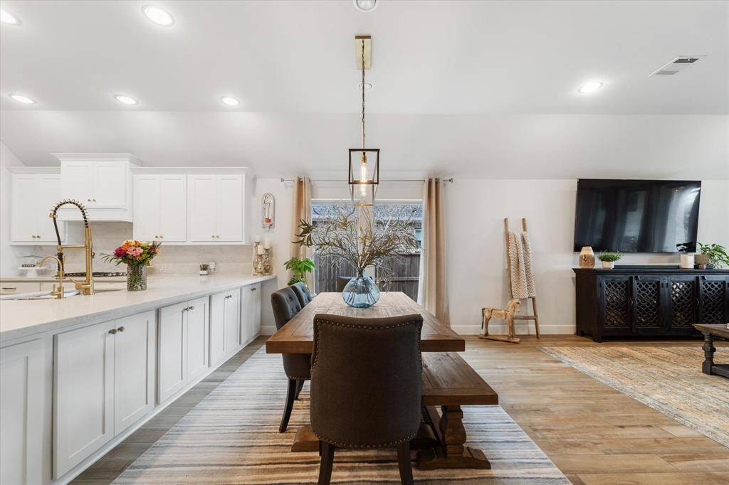 Unwind in the expansive living room with unobstructed views to your covered patio and beyond. This wood-look tile flooring flows effortlessly through the main living areas, offering both elegance and easy maintenance.