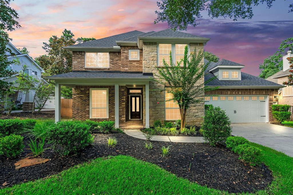 Welcome to this modern residence, showcasing a beautifully landscaped front yard, an inviting entrance, and a spacious two-car garage, all set against a stunning twilight sky.