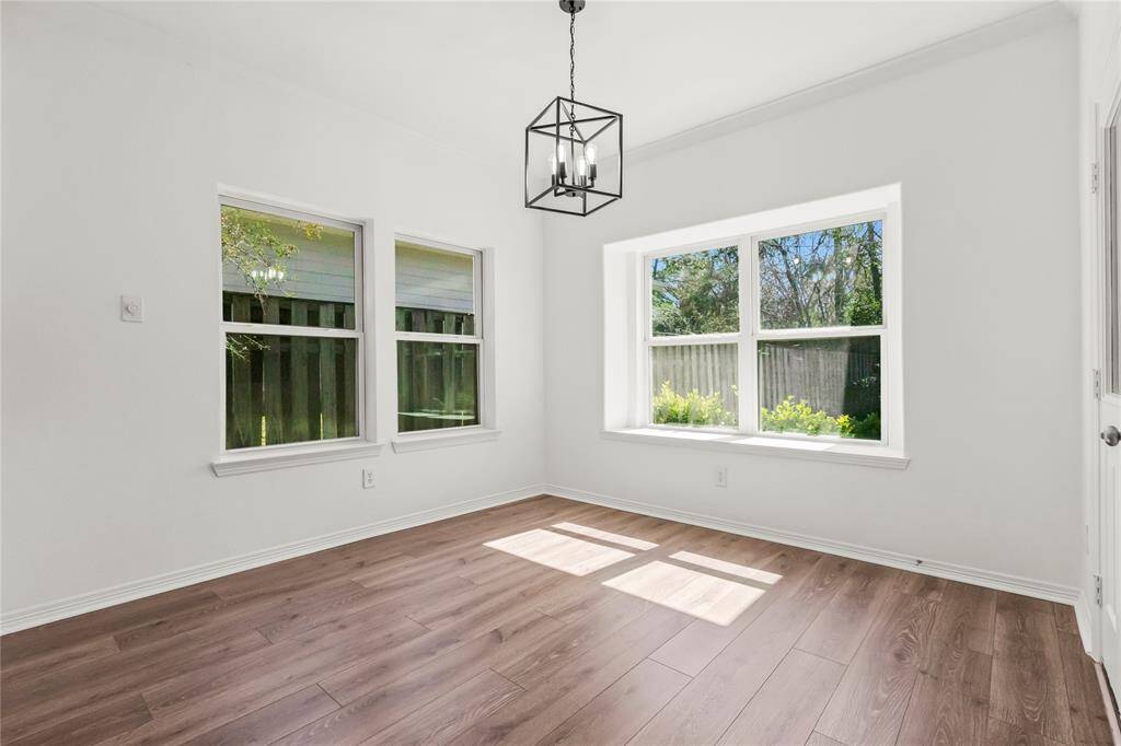 Bright and inviting breakfast area on the ground level, featuring large windows and stylish flooring. Perfect for morning coffee with a view.