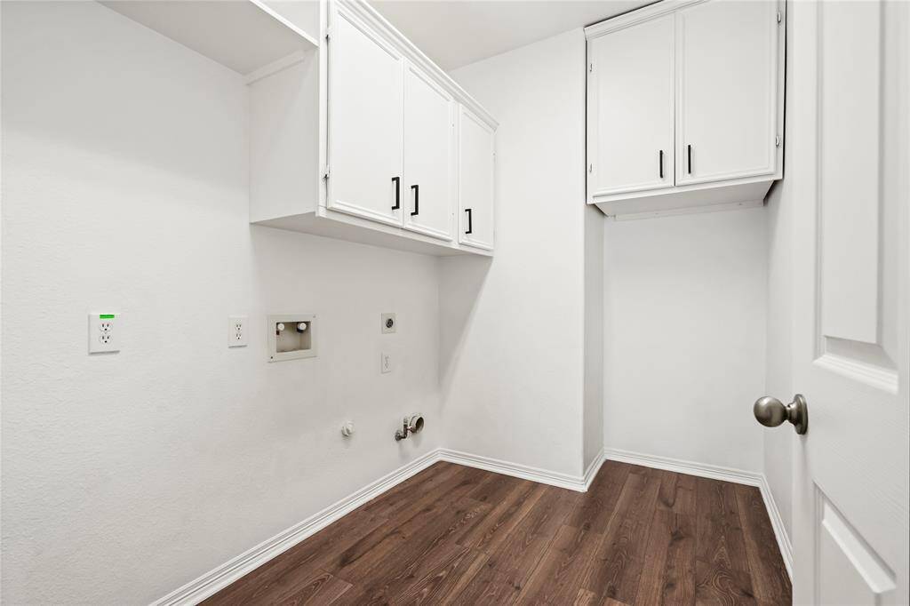 Spacious ground-level laundry area with ample storage and modern finishes.