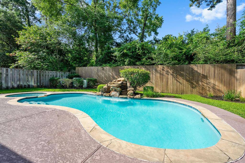 Inviting Backyard Oasis: Pristine Pool with Natural Stone Waterfall